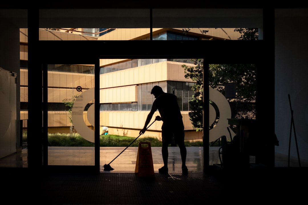 about-us Man cleans floor at an entrance door.